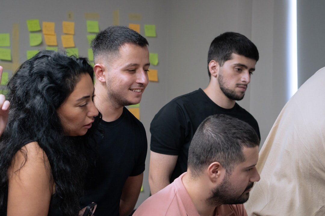 Startup team collaborating around a whiteboard with charts